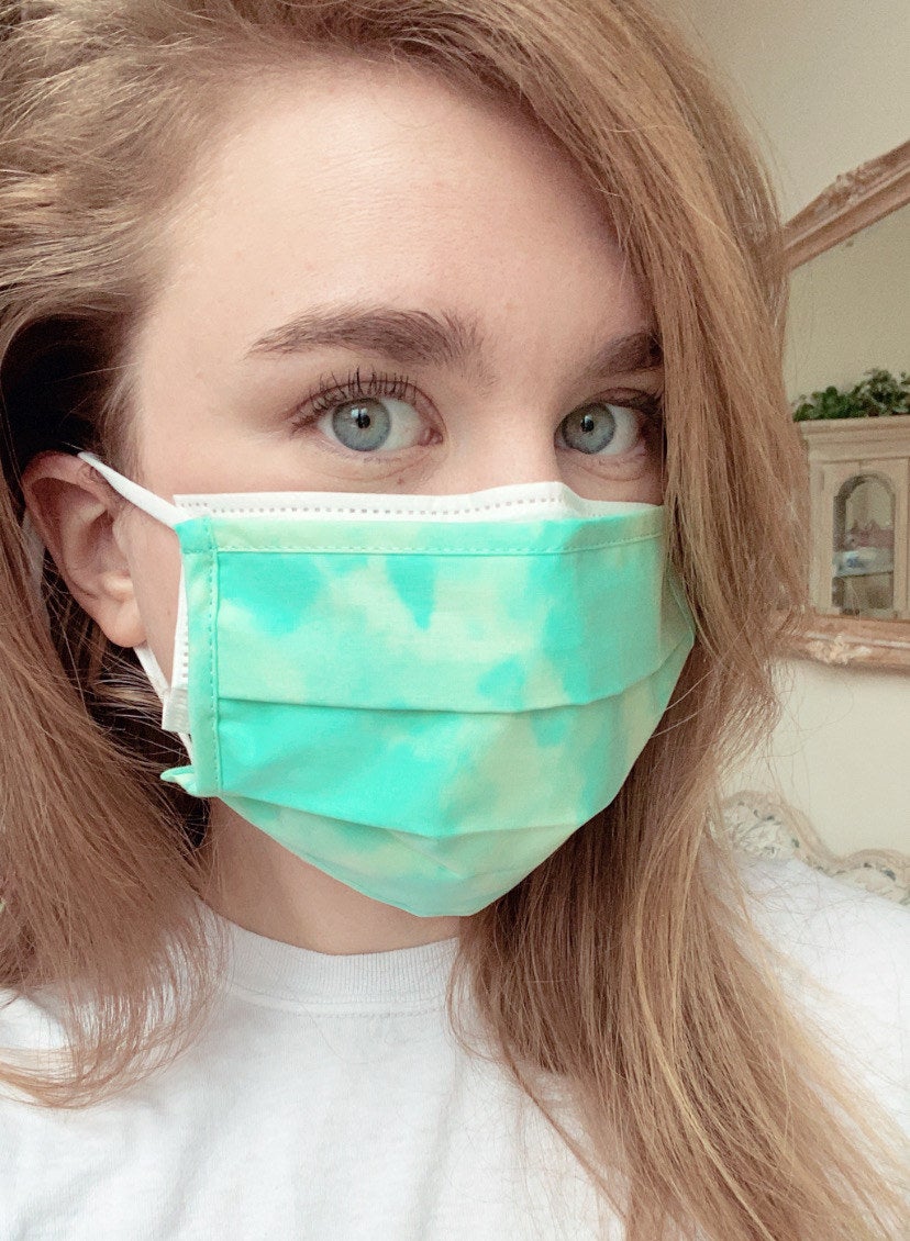 BuzzFeed editor with a reusable cloth face mask layered on top of a disposable face mask 
