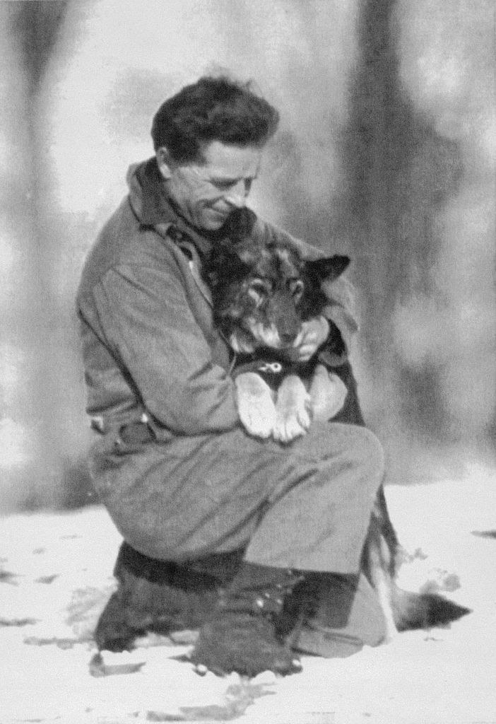 A man holding a husky in his arms