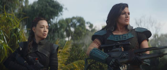 Ming-Na Wen and Gina Carano brandish firearms in an outdoor setting in The Mandalorian