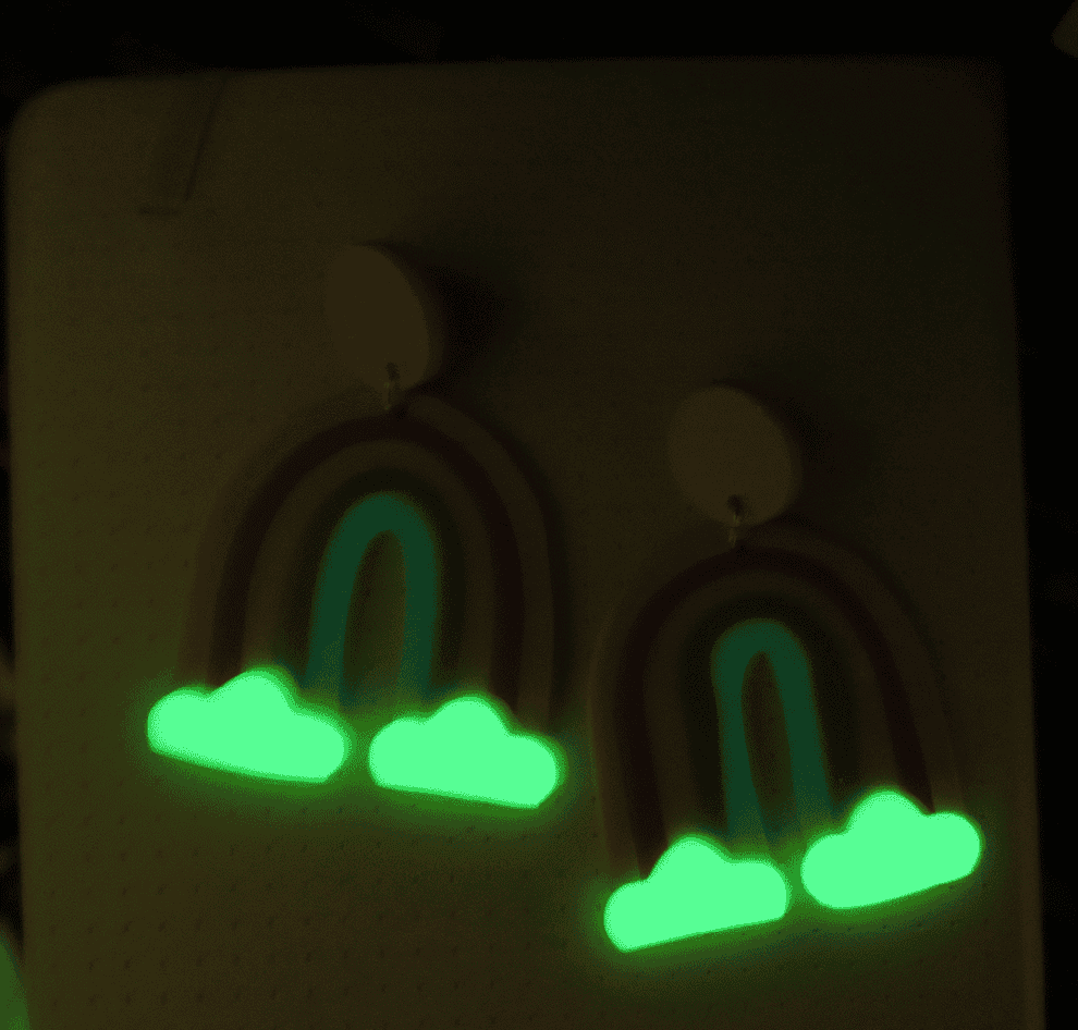 gif of large rainbow earrings in light and dark to show glowing clouds