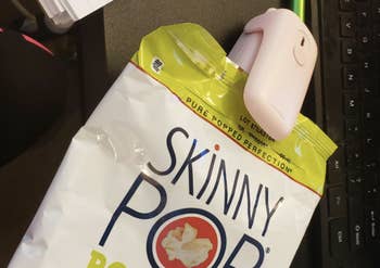 reviewer resealing bag of skinny pop