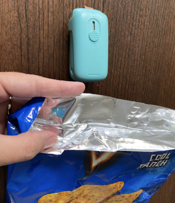 reviewer showing bag of chips that was resealed with bag sealer
