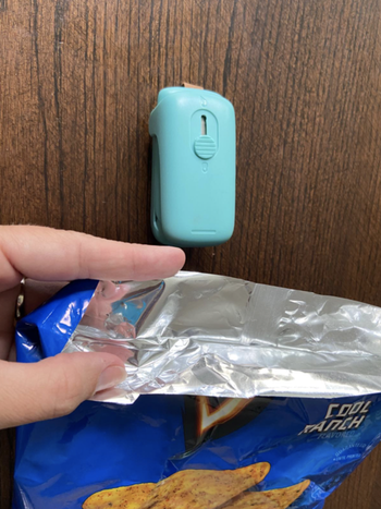 reviewer showing bag of chips that was resealed with bag sealer