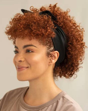 model with curly hair wearing the bandie in black 