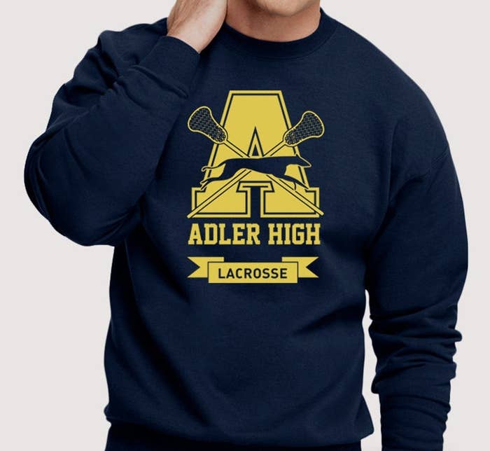 A person wearing a sweatshirt that says Adler High Lacrosse