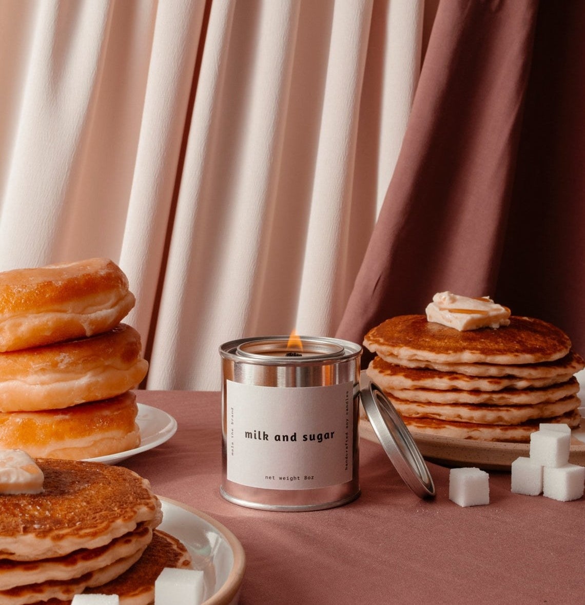 A candle surrounded by plates of pancakes
