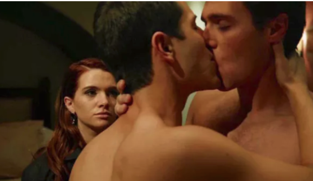 Two guys kissing while a friend watches in an MTV scripted series