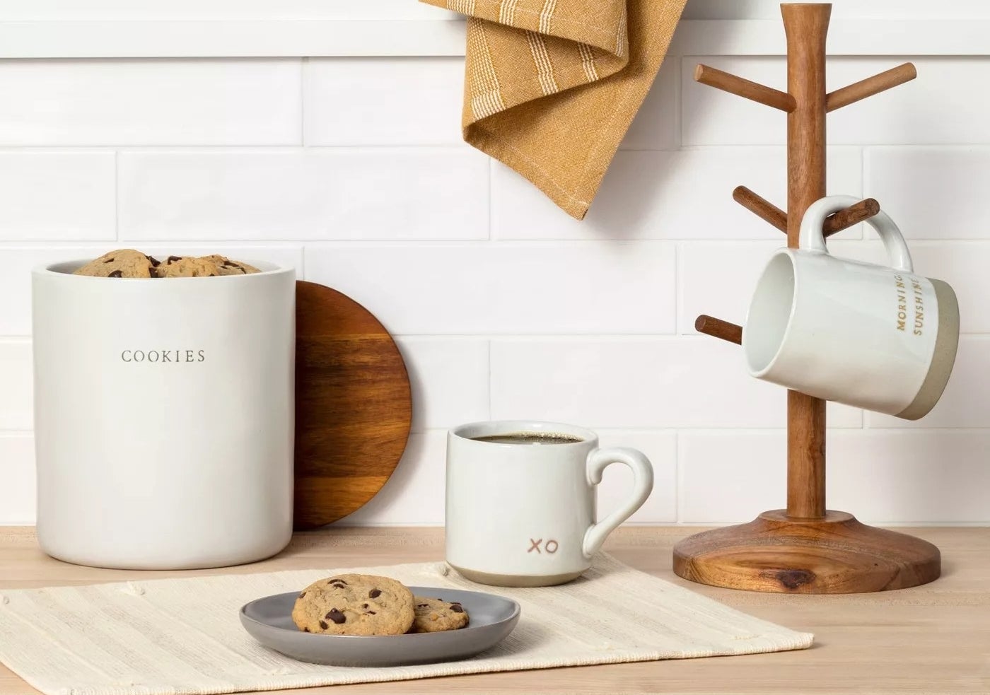 cookie jar next to mug and plate on counter