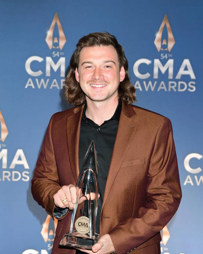 Morgan Wallen poses with an award at the CMA Awards