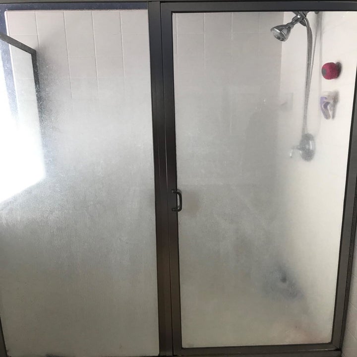 Reviewer photo of dirty glass shower door