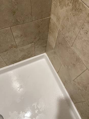 Reviewer's same shower after cleaning with mold and mildew remover now clean