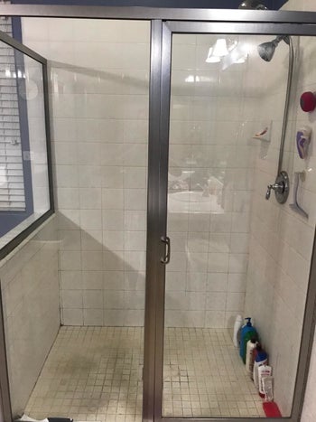 Reviewer's same shower door after cleaning with Rain-X cleaner