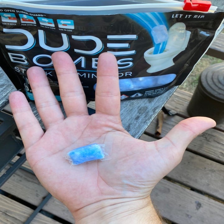 Reviewer holding Dude Bombs Stank Eliminator