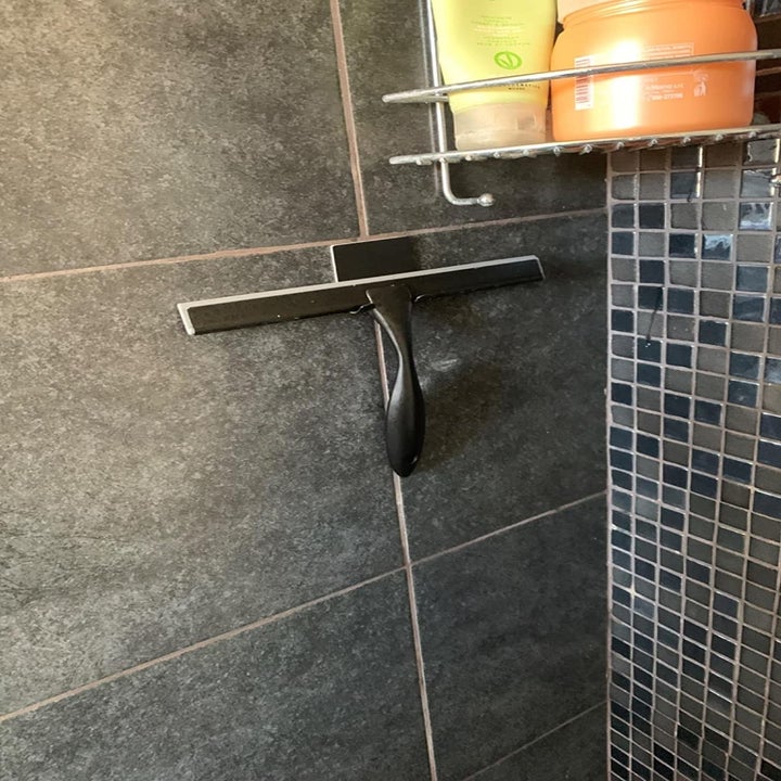 Squeegee hanging on included adhesive hook