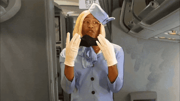 flight attendant putting on a mask