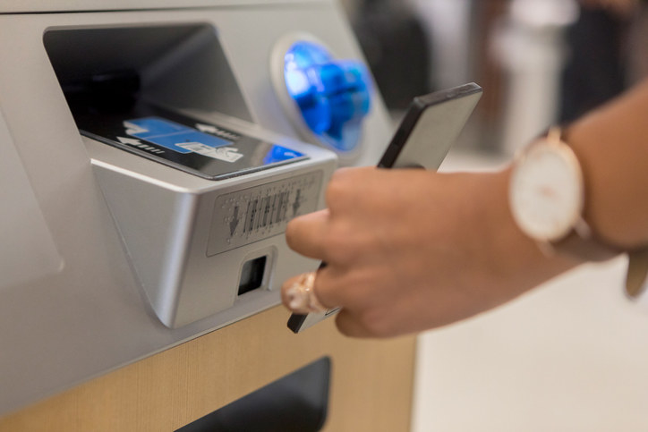 person using a check in kiosk at the airport