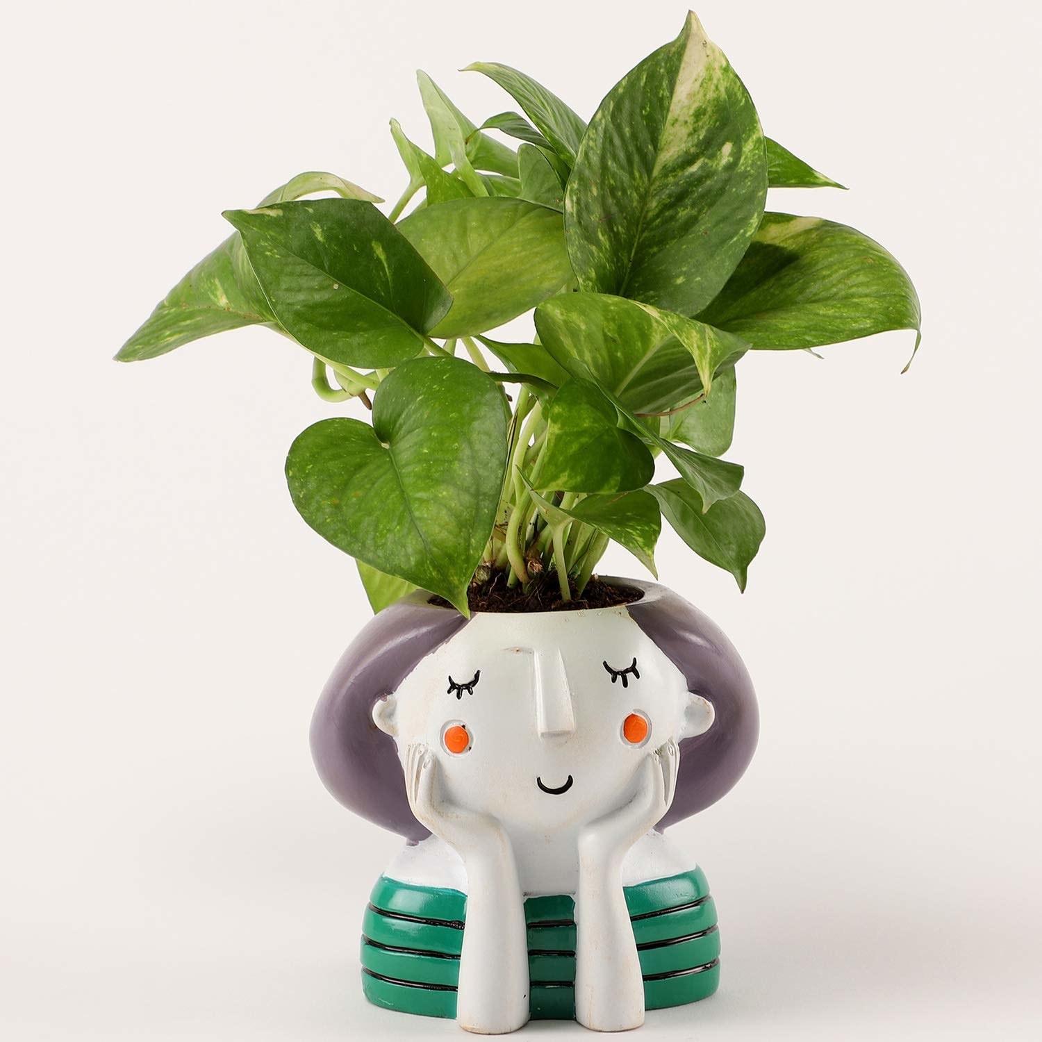 The plant kept in a pot designed to look like a thinking girl