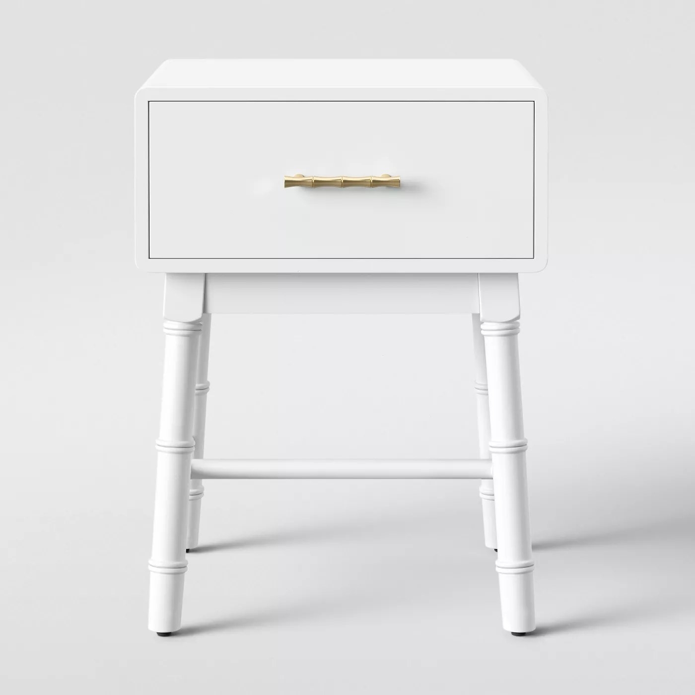 The blue nightstand with a gold handle