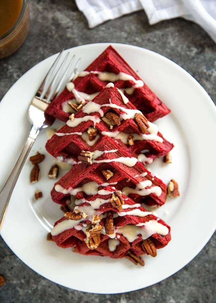 Red velvet waffles with walnuts and cream cheese icing.