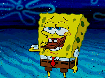 Spongebob rubbing his teeth on a chocolate bar