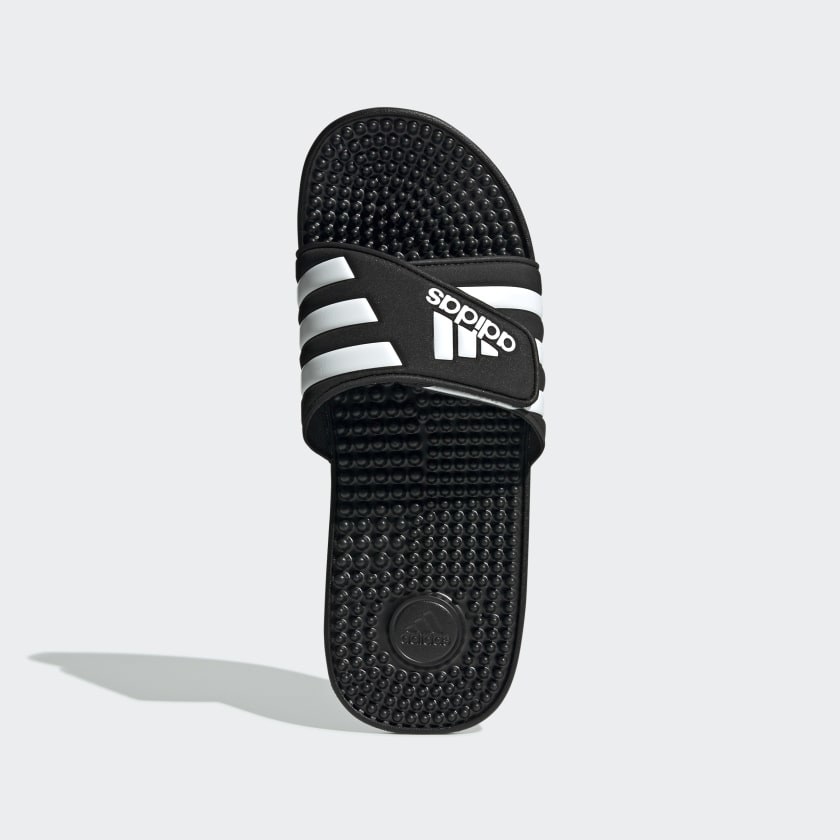 black adidas slide shoes with nubs on the bottom to massage your feet