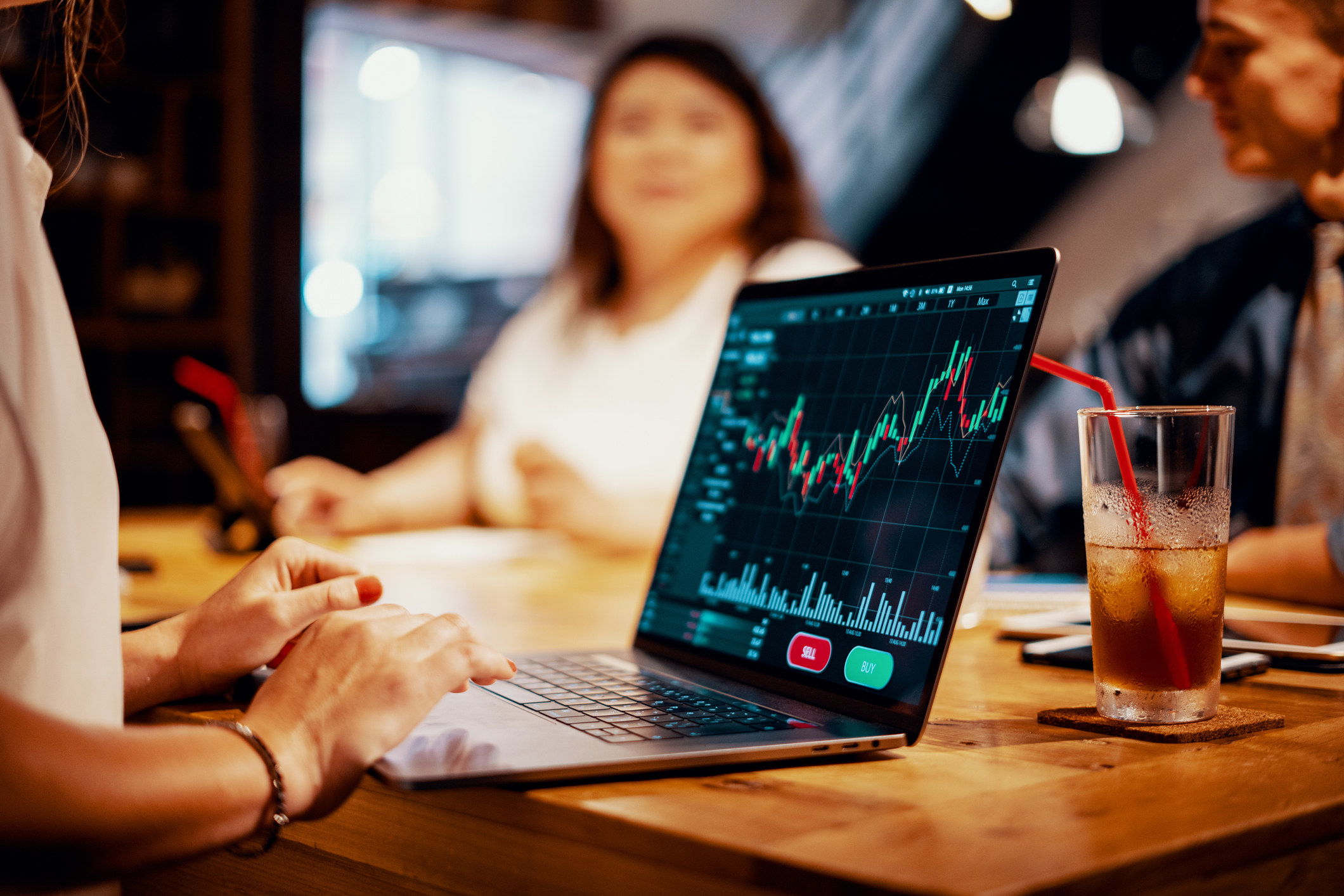 Model looking at stock charts on a laptop