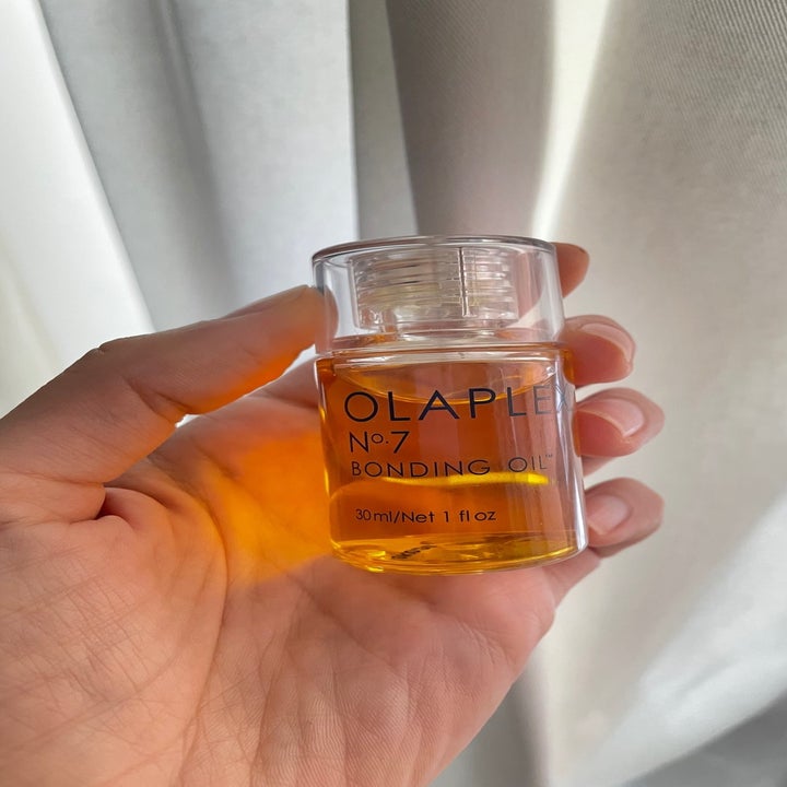 A person holding the Olaplex oil