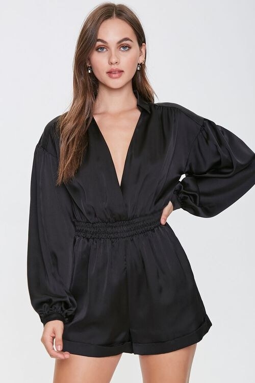 model wearing the long sleeve romper with a collar and plunging neckline in black