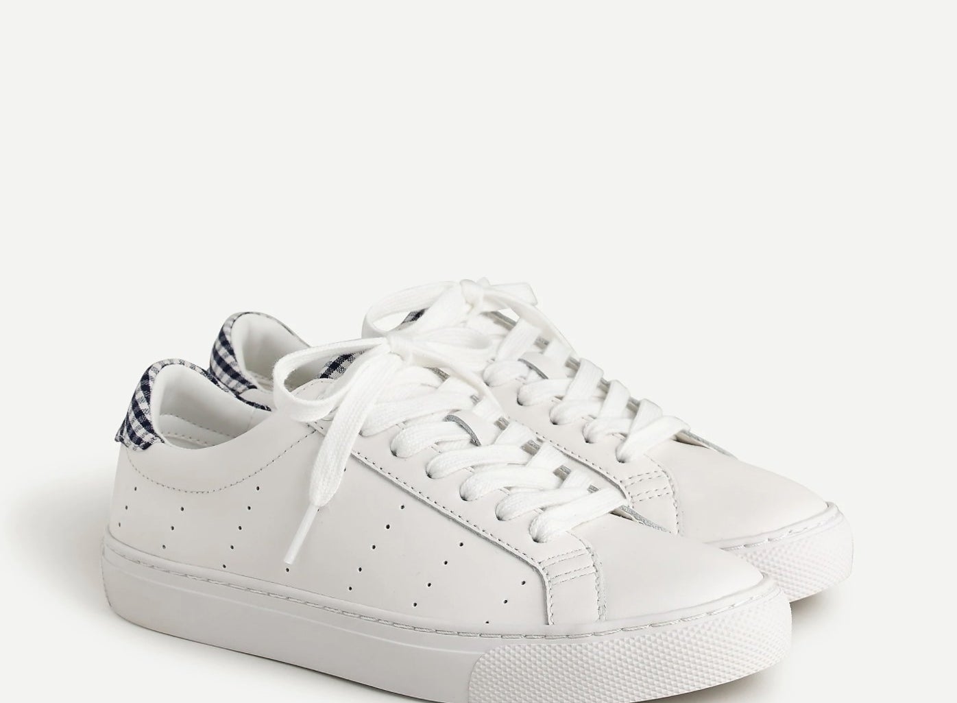 The sneakers in white with gingham on the heels