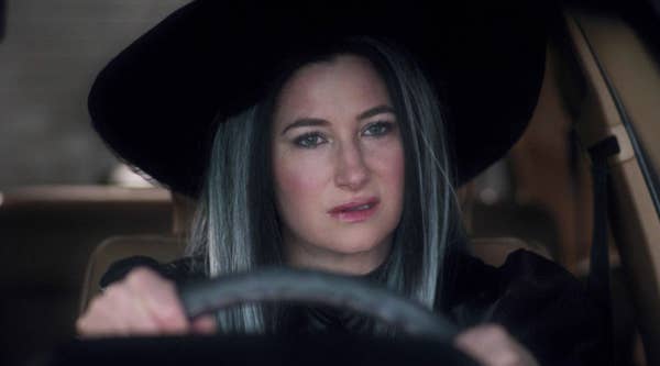 Agnes dressed as a witch as she sits behind the wheel of a car
