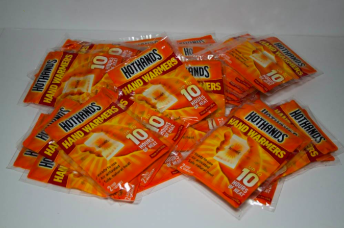 a reviewer&#x27;s photo of many hand warmers 