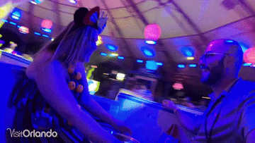 Two people spinning on the teapot ride.