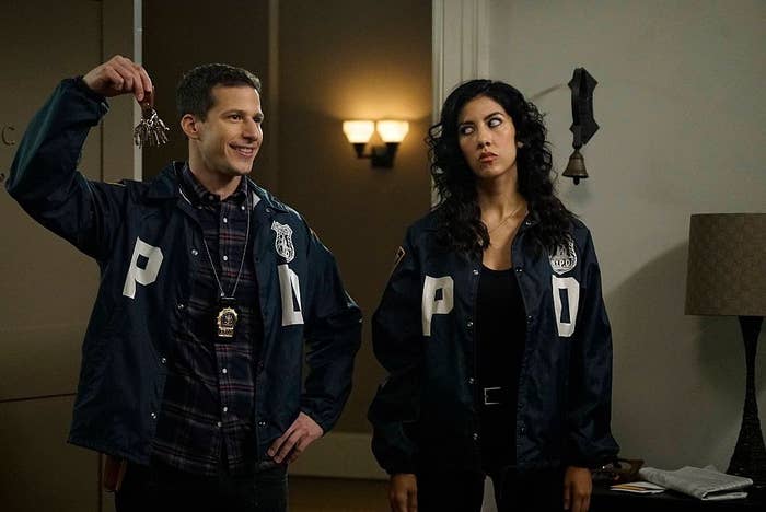 Andy Samberg holding up keys as Stephanie Beatriz gives him the side-eye in BROOKLYN NINE-NINE 