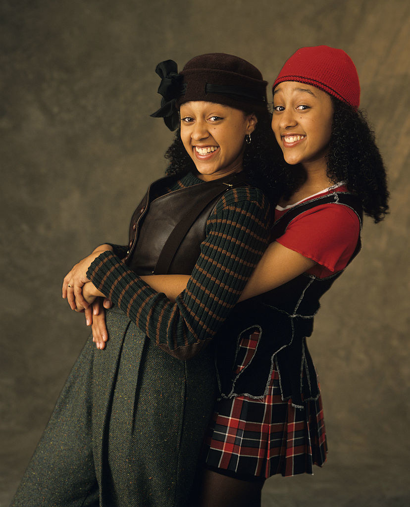 Tamera Mowry and Tia Mowry embracing in promo photo 