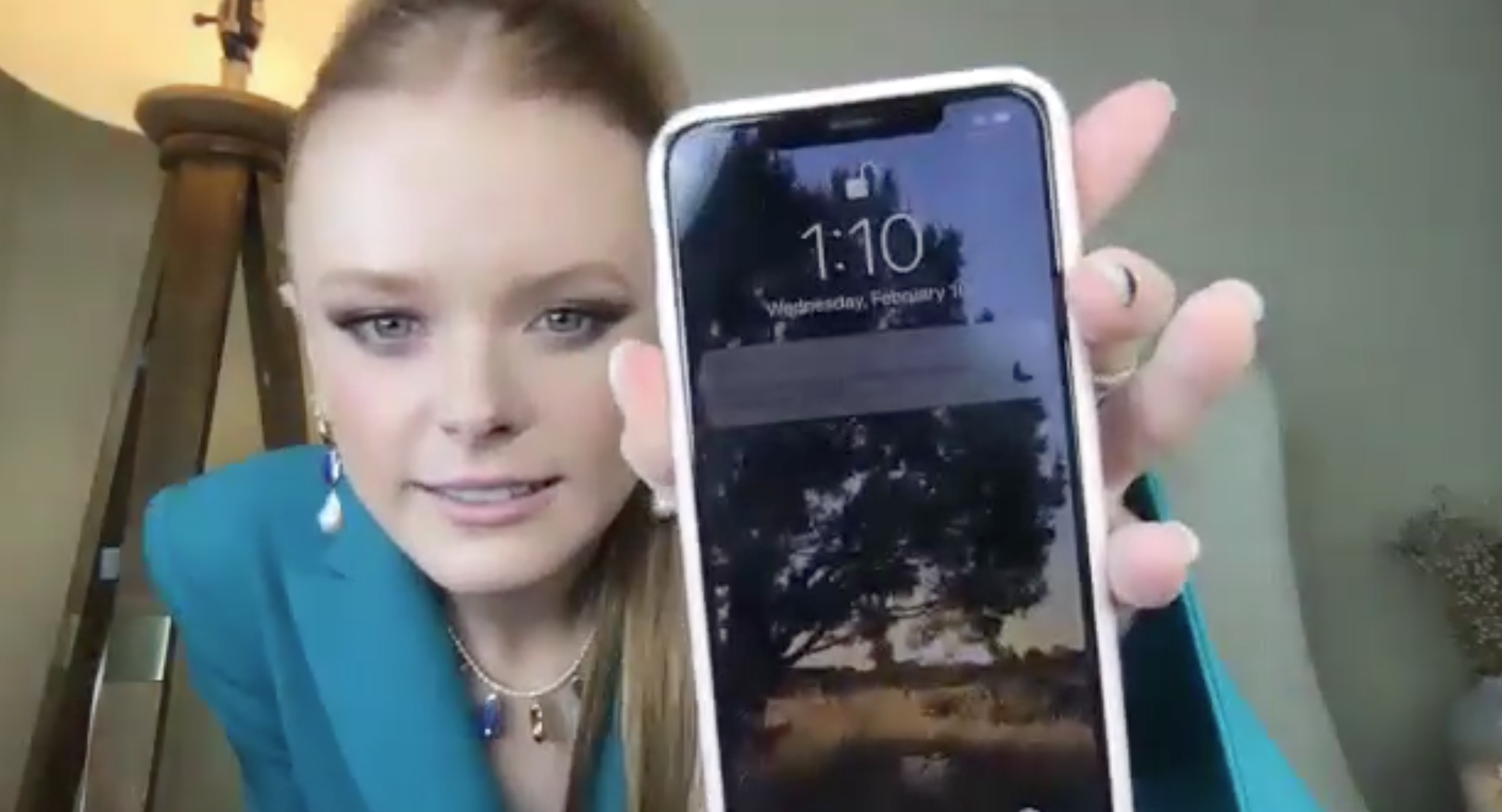 Abigail holding her phone to the camera 