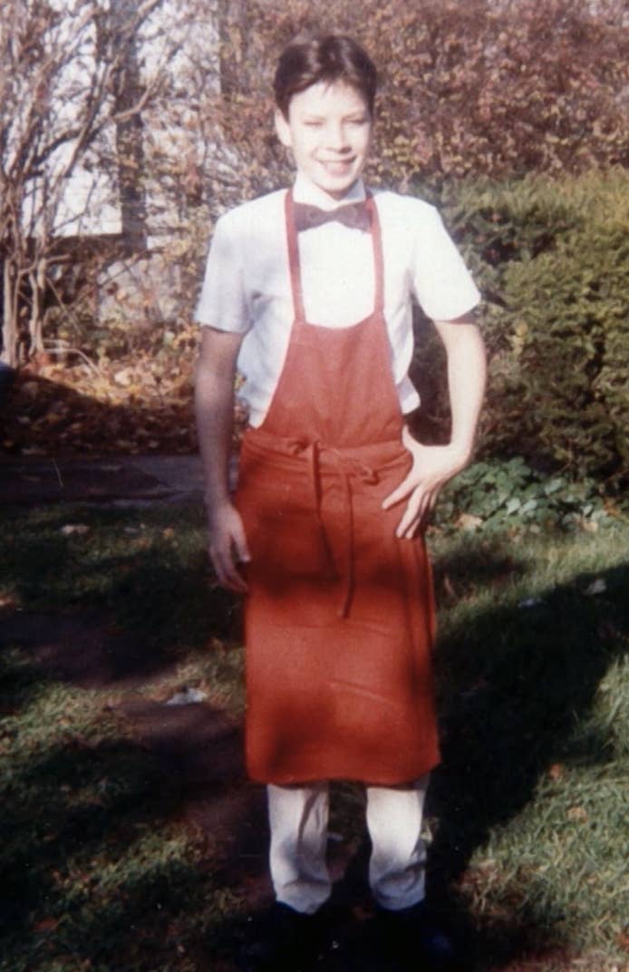 Jimmy wearing a shirt, bowtie, slacks, and an apron