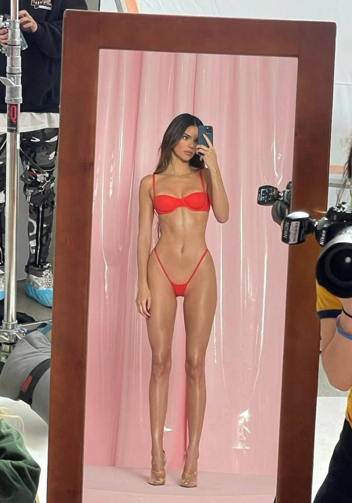 Kendall posing for a selfie wearing the underwear, looking very thin and long-bodied
