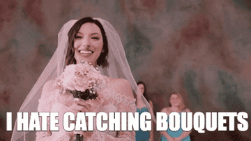 Bride throwing a bouquet with caption &quot;I hate catching bouquets&quot;