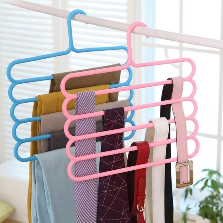 A 5-layer hanger with clothes in it