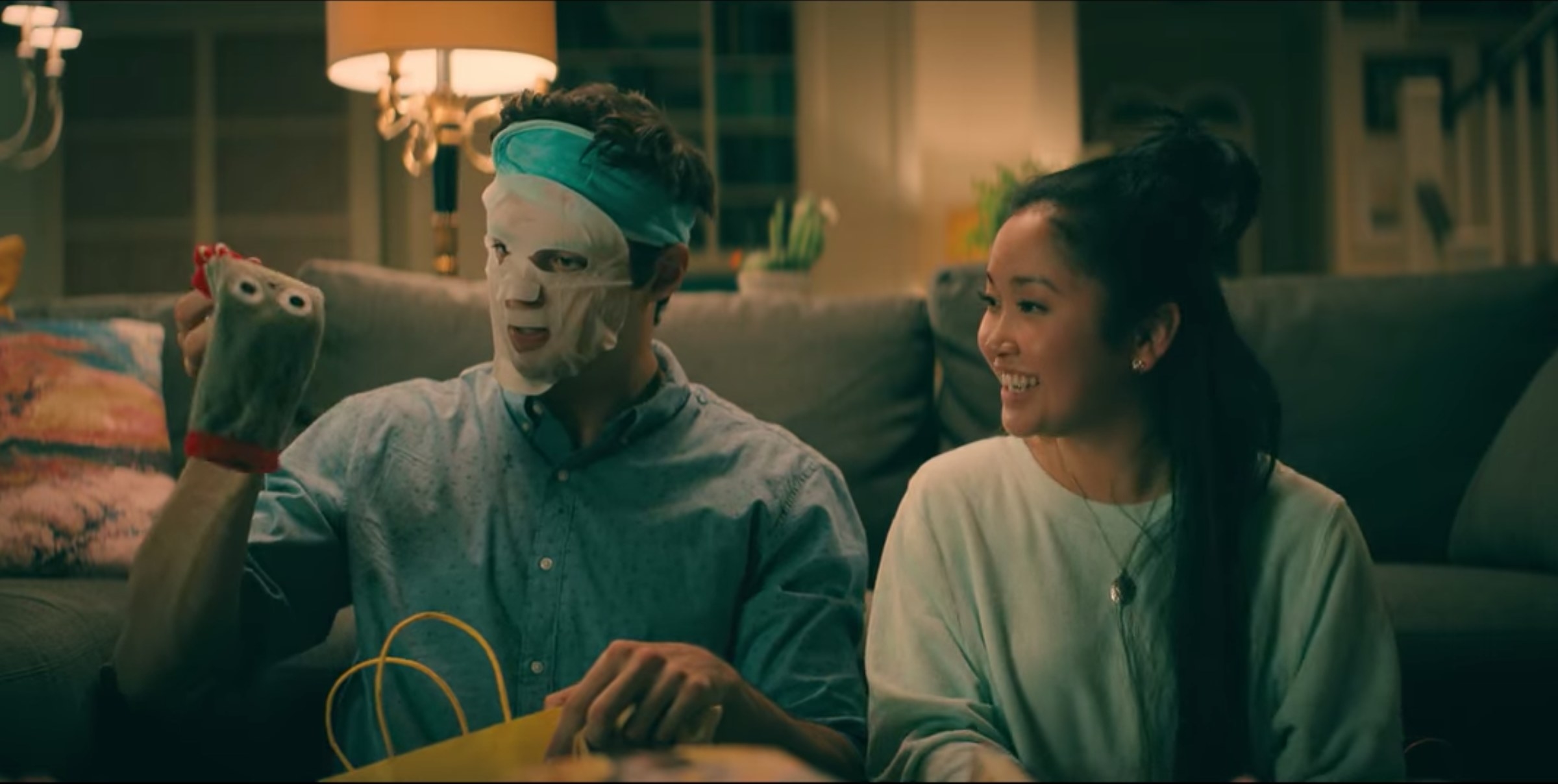 Peter wearing a face mask and holding character socks