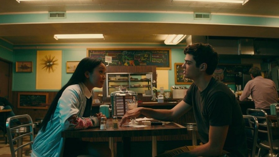 Lara Jean and Peter sitting at a cafe table