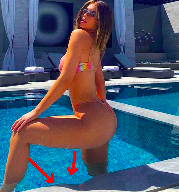 Kylie Jenner wearing a bikini and standing in a pool by the side with one leg bent