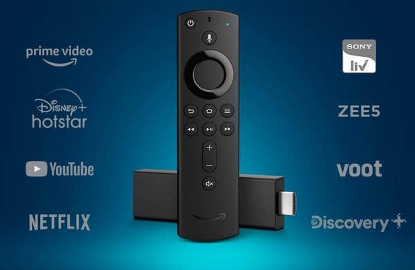 A Fire TV Stick with logos of various supported streaming platforms such as Disney Hotstar, Netflix, YouTube, and others