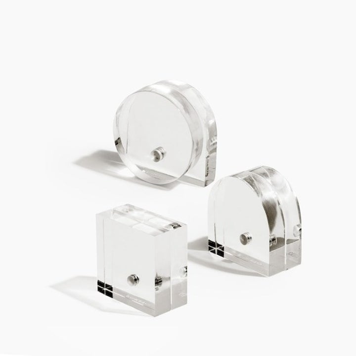 A close-up of the three, transparent, geometric stands   