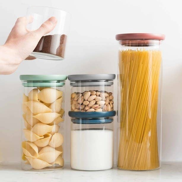 Five glass food storage containers with various ingredients stored in them 