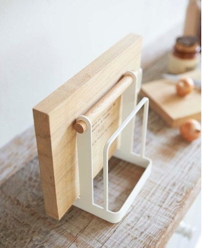 The cutting board stand with a cutting board in it 