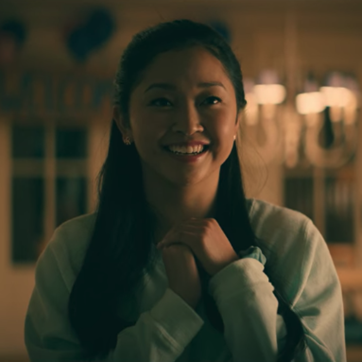 Lara Jean watching the proposal with a smile on her face