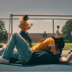 Lara Jean and Peter kissing while on the track field