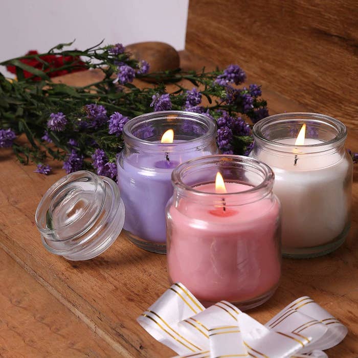 3 scented candles on a table 