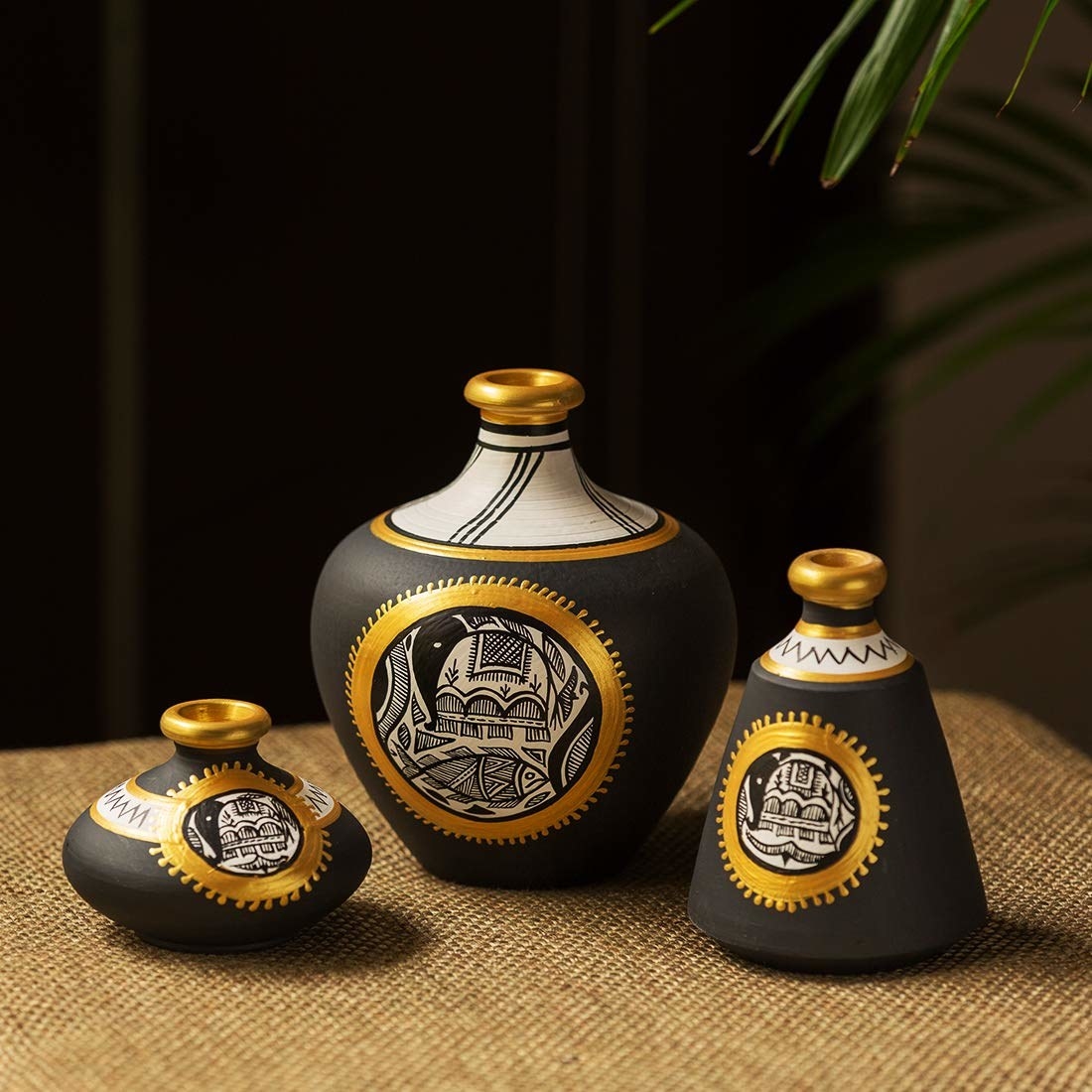 Black, gold, and white Madhubani terracota matkis